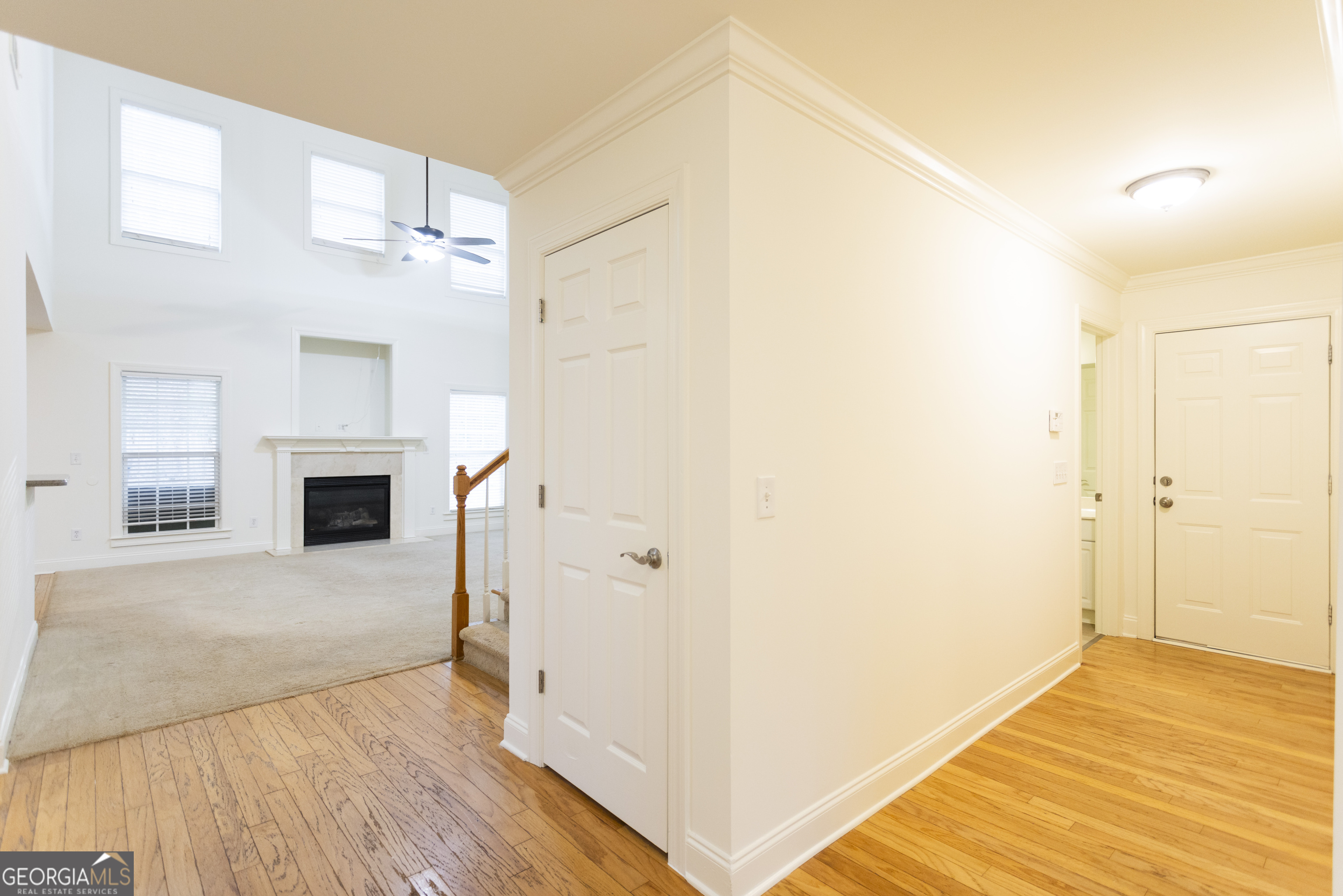 931 Bethany Road Covington, GA 30016 - Photo 50 of 83 a view of a livingroom with wooden floor and a kitchen space