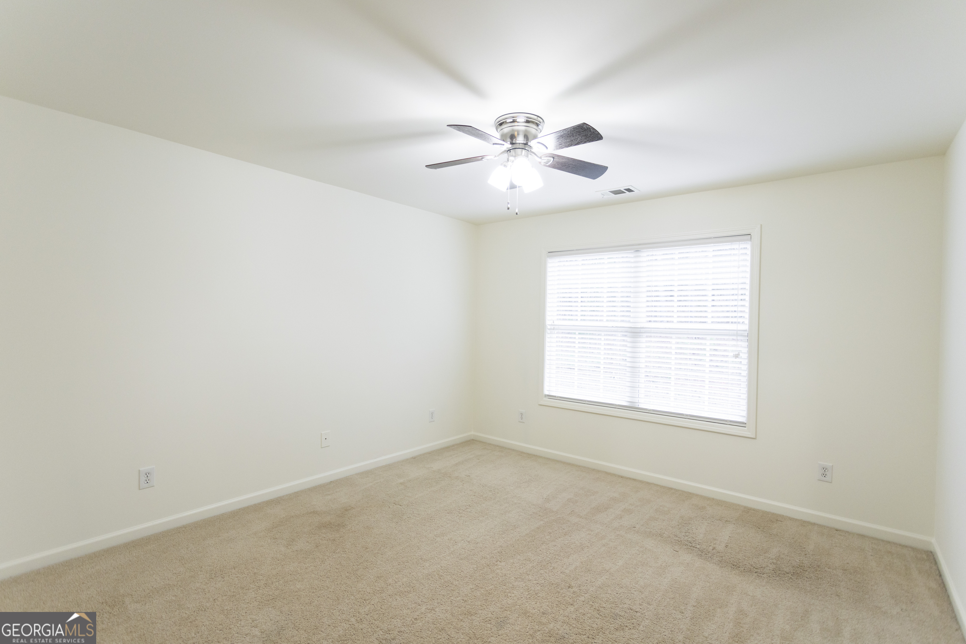 931 Bethany Road Covington, GA 30016 - Photo 55 of 83 an empty room with a window and a fan