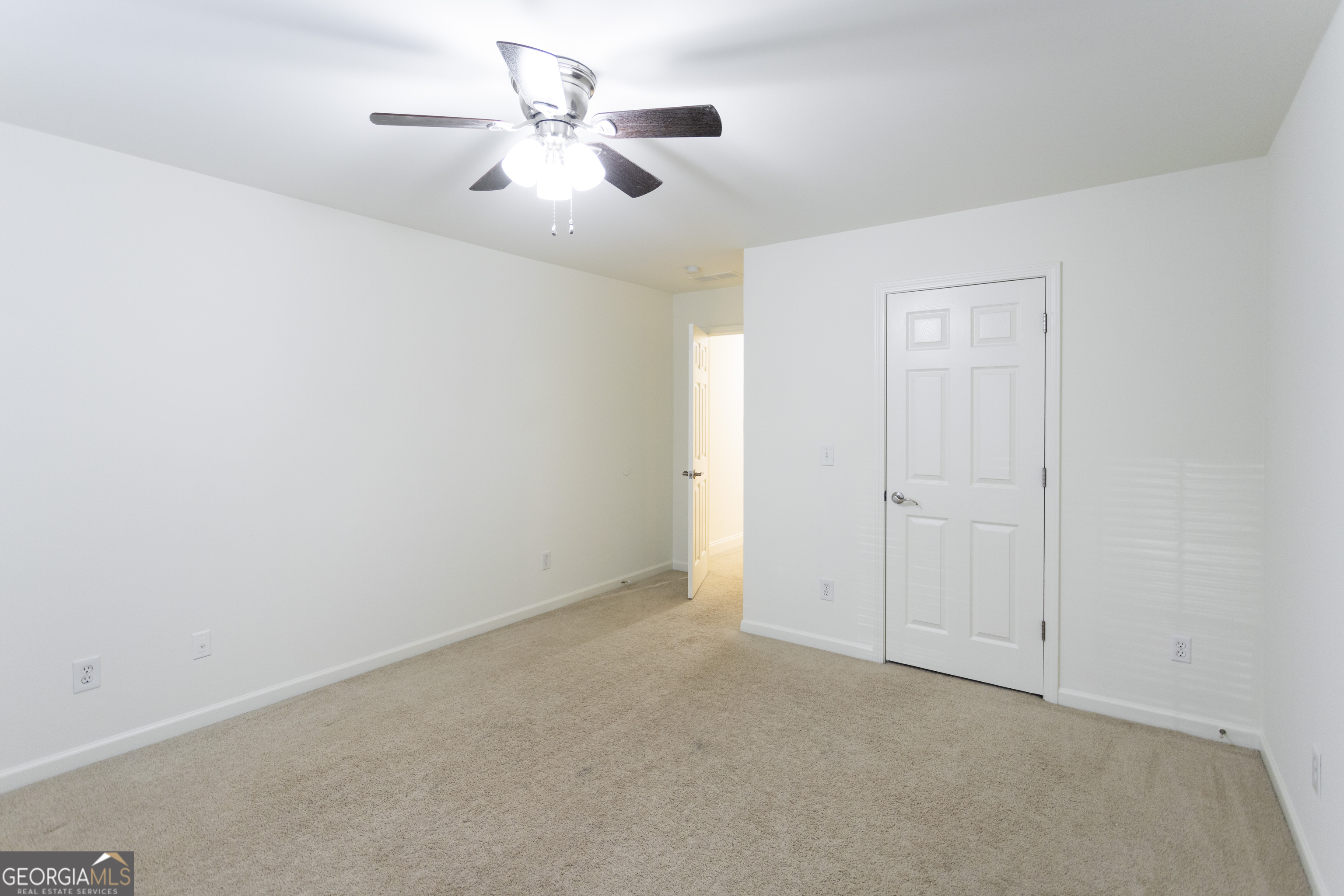 931 Bethany Road Covington, GA 30016 - Photo 57 of 83 an empty room with chandelier fan and windows