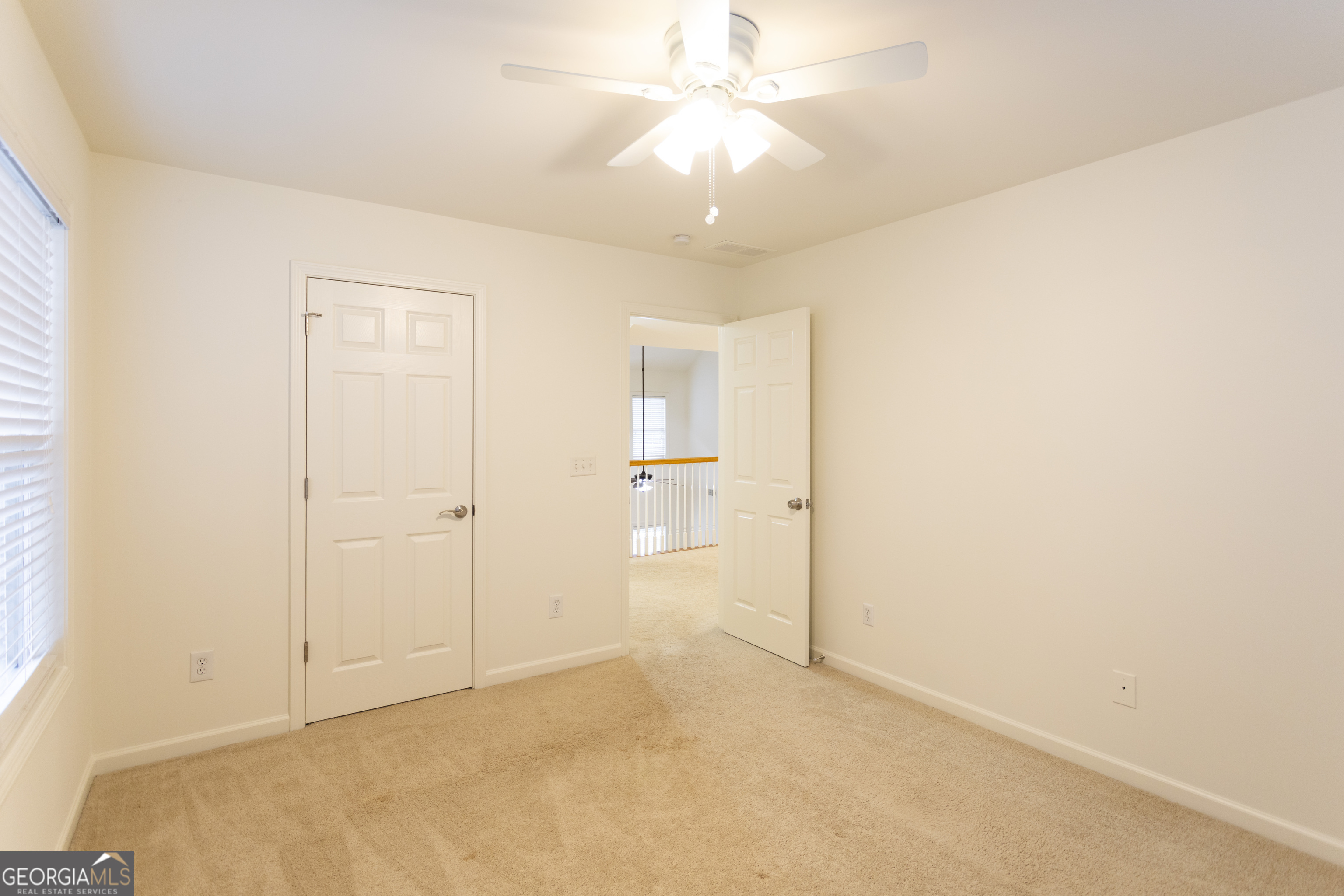 931 Bethany Road Covington, GA 30016 - Photo 61 of 83 an empty room with a ceiling fan and a window