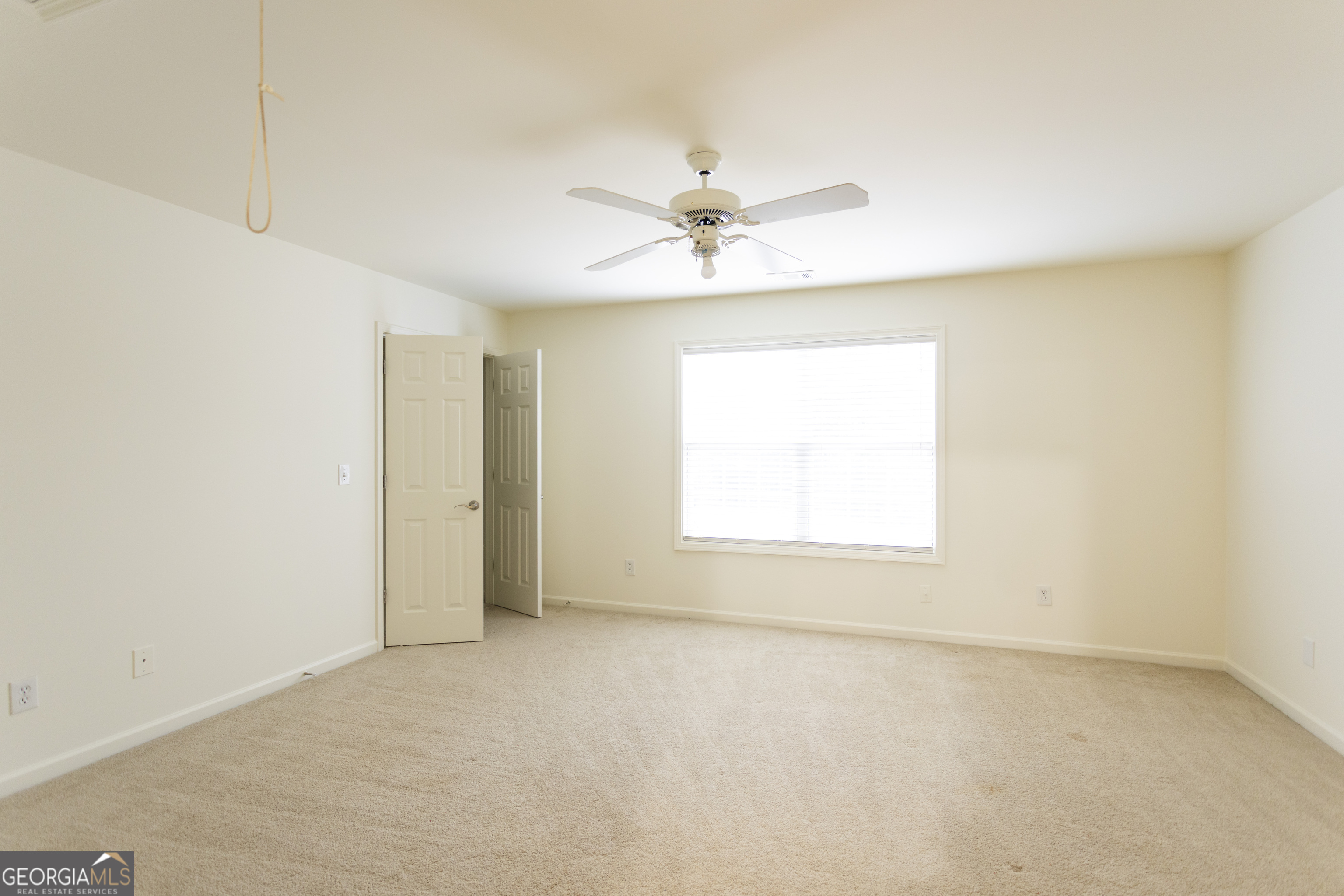 931 Bethany Road Covington, GA 30016 - Photo 69 of 83 an empty room with a window and a ceiling fan