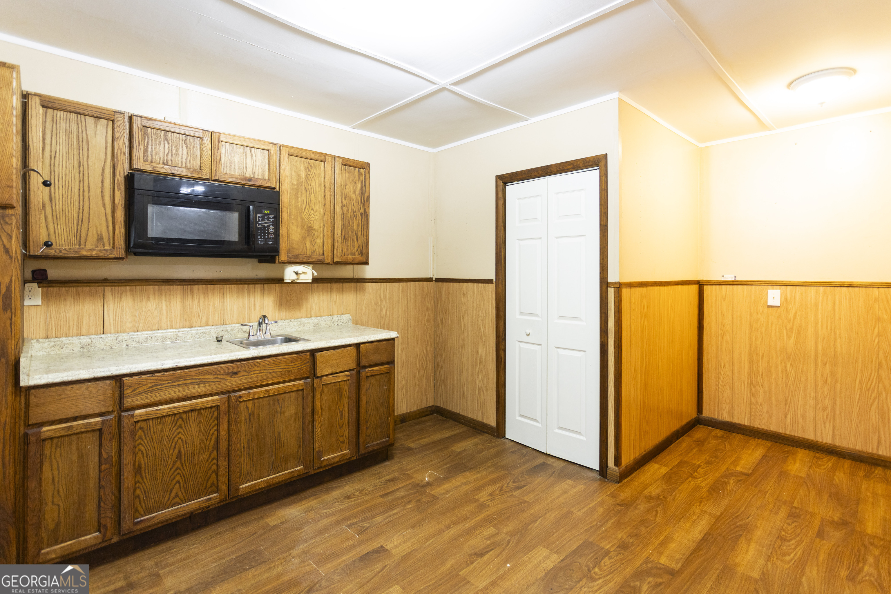 931 Bethany Road Covington, GA 30016 - Photo 73 of 83 a kitchen with stainless steel appliances granite countertop a stove a sink and a microwave