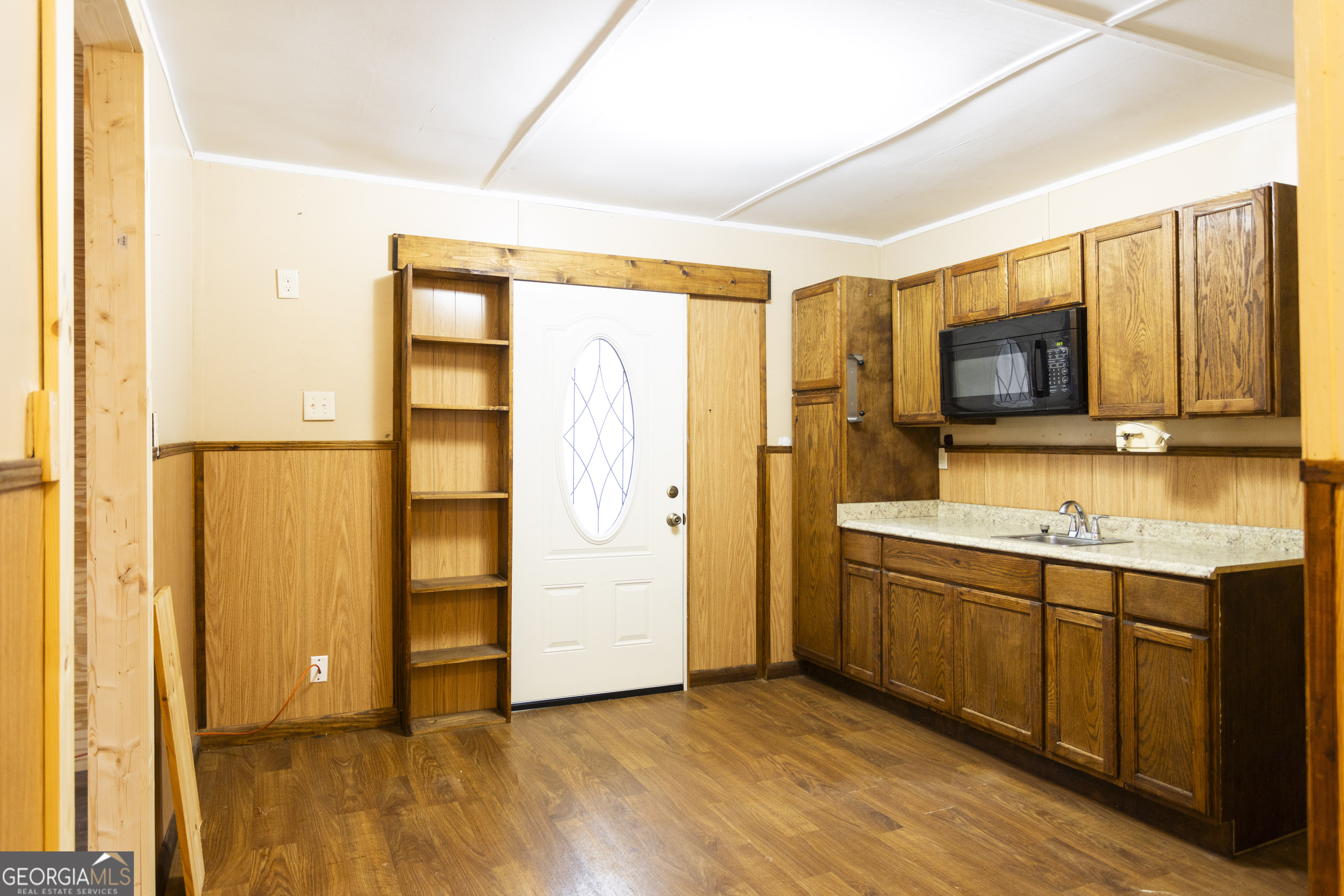931 Bethany Road Covington, GA 30016 - Photo 74 of 83 a view of a kitchen with a sink and a refrigerator
