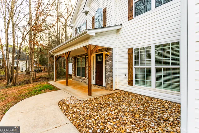 a view of a house with a yard and sitting area