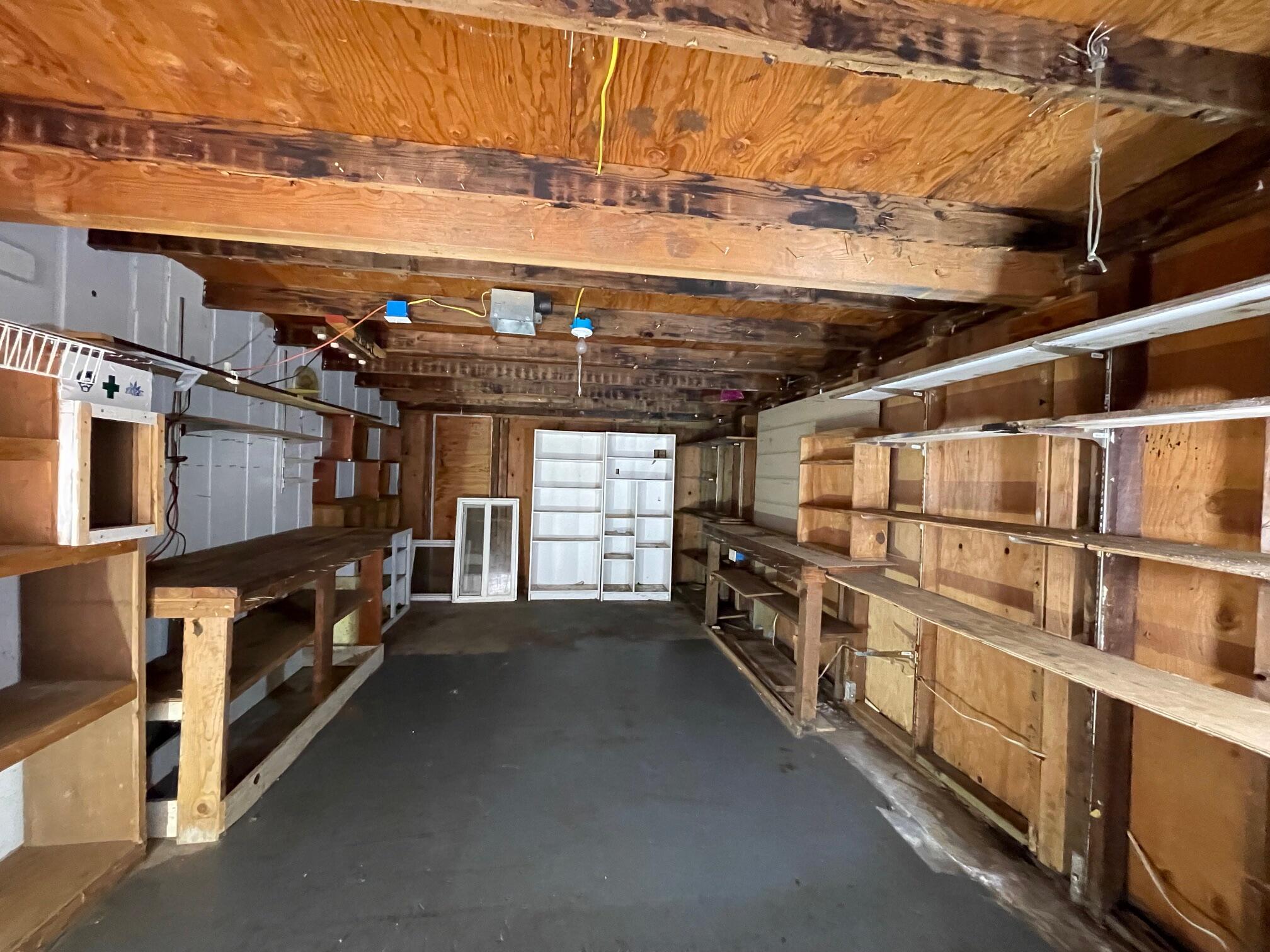 411 South Old Stage Road Cave Junction, OR 97523 - Photo 18 of 39 a view of an empty room with racks on the wall