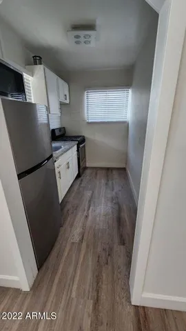 a kitchen with a wooden floor and a stove