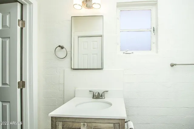 a bathroom with a sink and a mirror