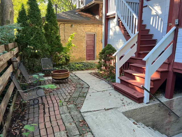a view of a backyard with sitting area