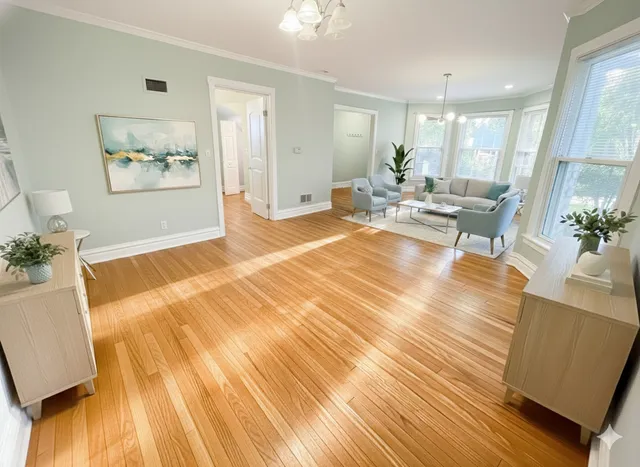 a living room with furniture and wooden floor