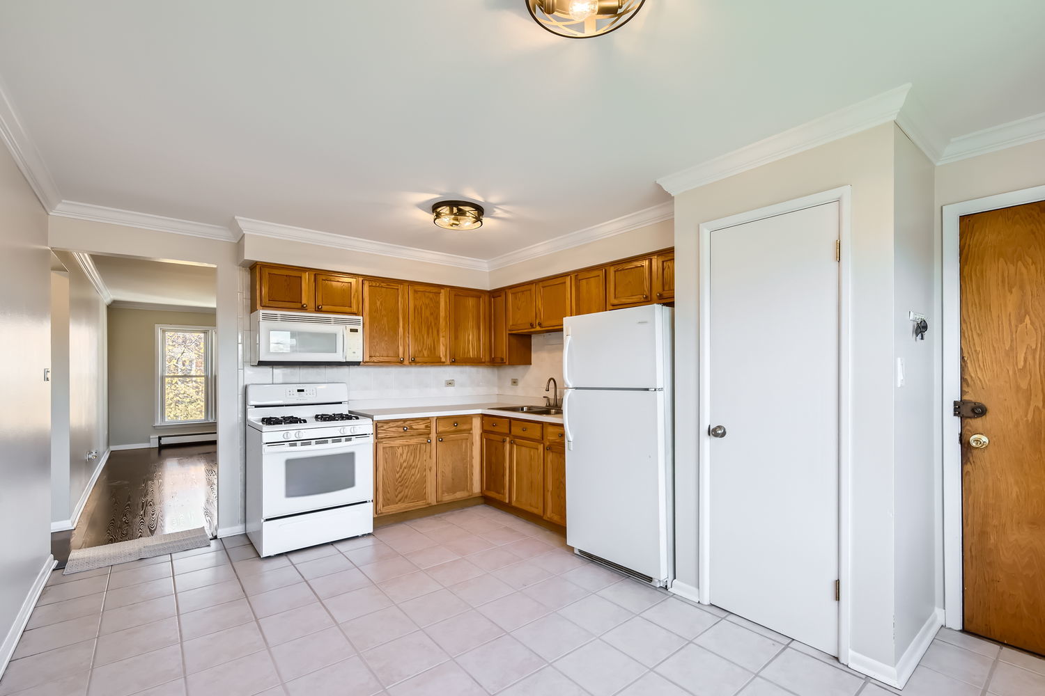 10767 South Pulaski Road, Unit 5 Chicago, IL 60655 - Photo 6 of 10 a kitchen with a refrigerator a stove top oven and a sink