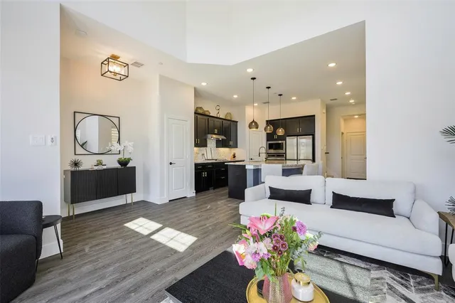 a living room with furniture and wooden floor