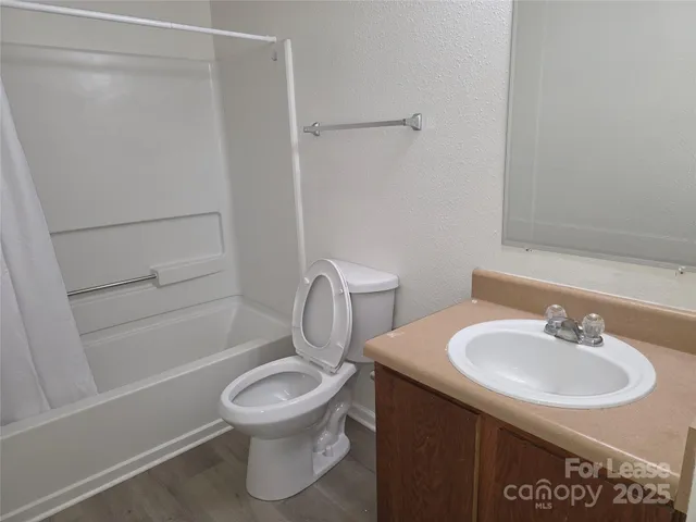 a bathroom with a sink toilet and a mirror