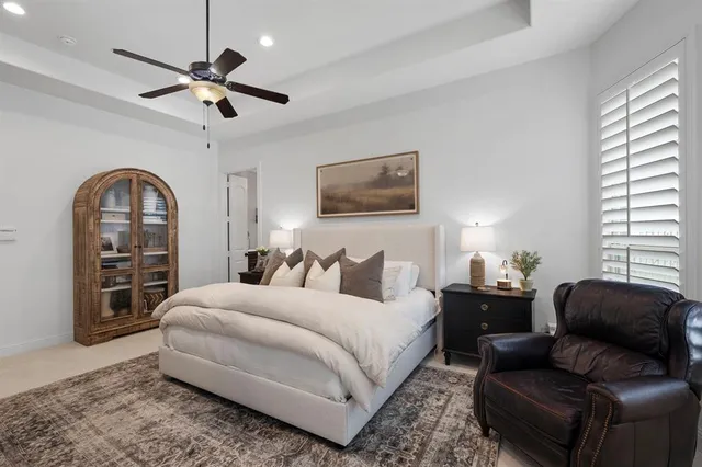 a bedroom with a large bed couch and a window