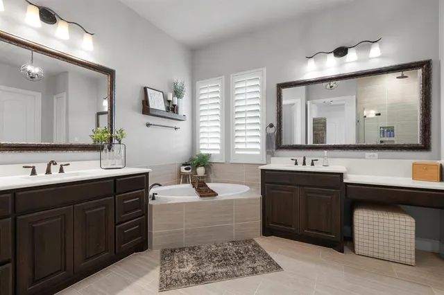 a bathroom with a sink double vanity and a mirror