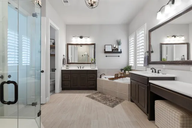 a large bathroom with a sink a toilet a mirror and vanity