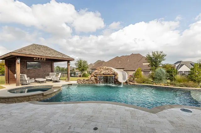 a view of a patio with a table chairs and backyard