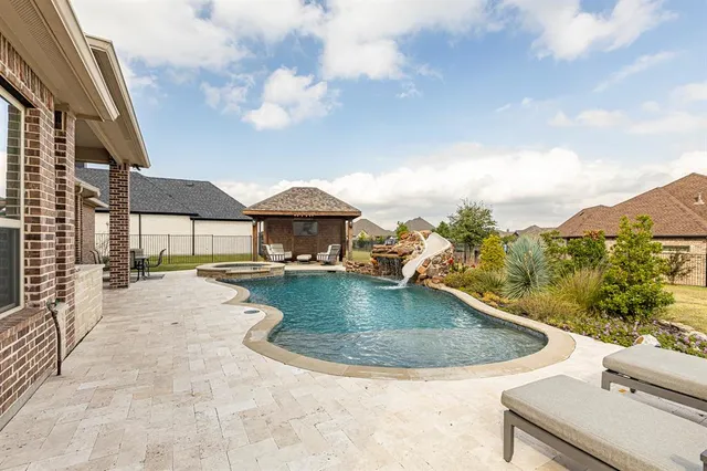 a view of a terrace with a garden and barbeque oven