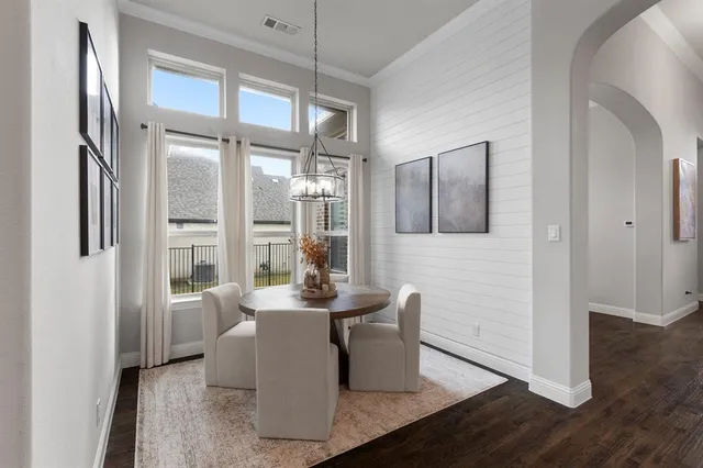 a dining room with furniture and wooden floor