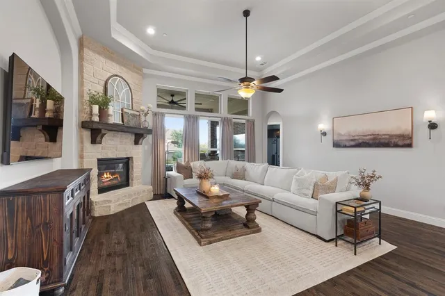 a living room with furniture a fireplace and a flat screen tv