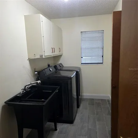 a room with a sink and cabinets