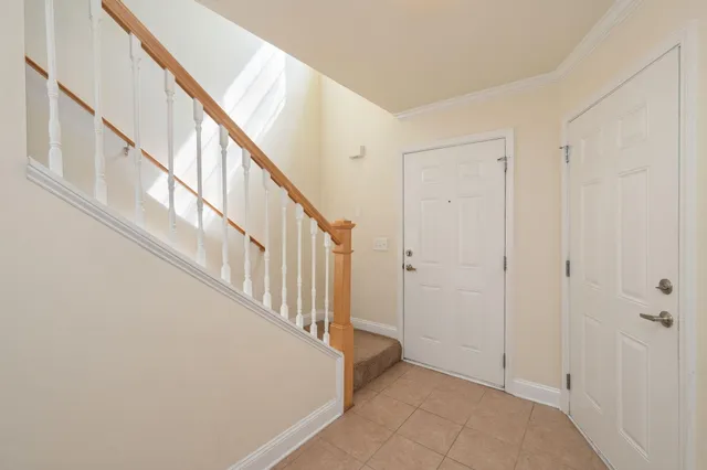 an empty room with windows and ceiling fan