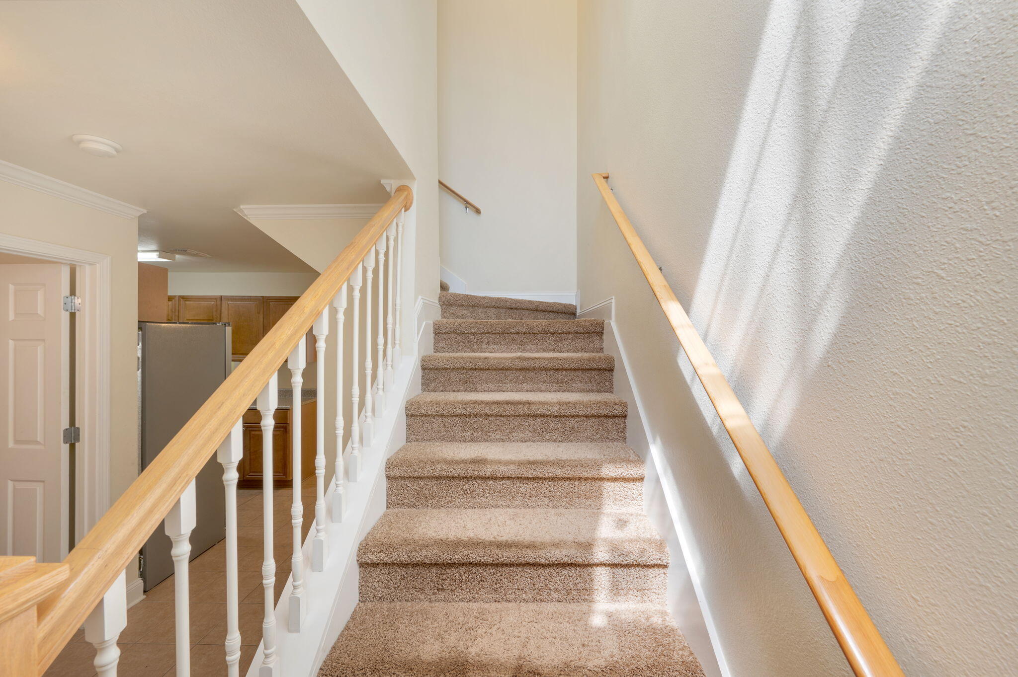 535 Wingspan Way Crestview, FL 32536 - Photo 24 of 26 a view of staircase with lots of frames on wall and wooden floor