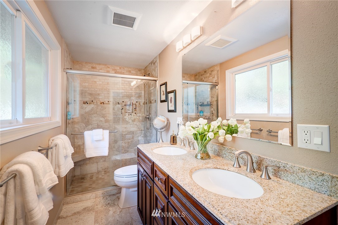 13621 196th Avenue Southeast Renton, WA 98059 - Photo 14 of 31 a bathroom with a granite countertop sink toilet a mirror and shower