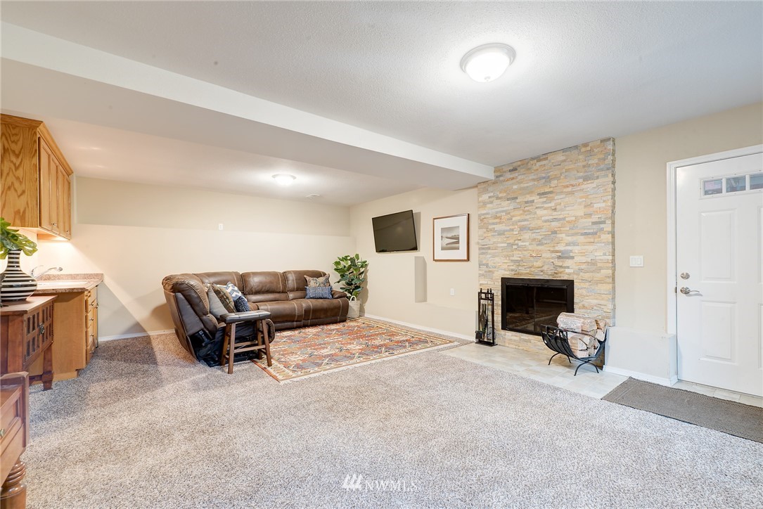 13621 196th Avenue Southeast Renton, WA 98059 - Photo 20 of 31 a living room with furniture and a fireplace