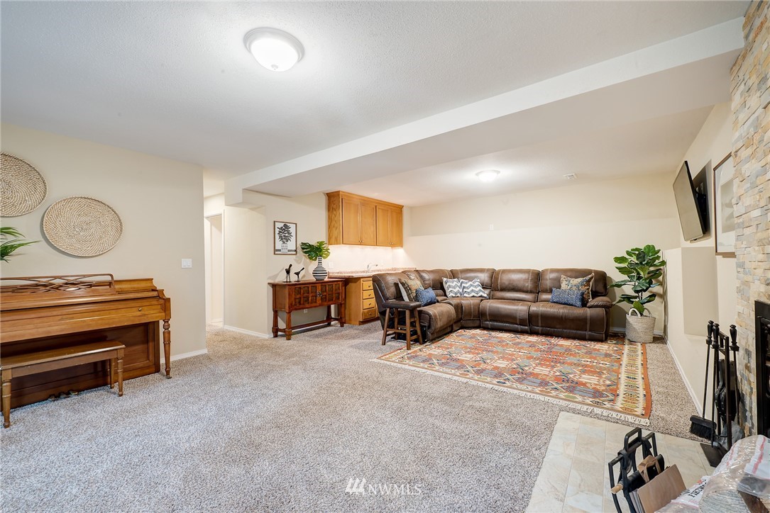 13621 196th Avenue Southeast Renton, WA 98059 - Photo 21 of 31 a living room with furniture gym equipment and a flat screen tv