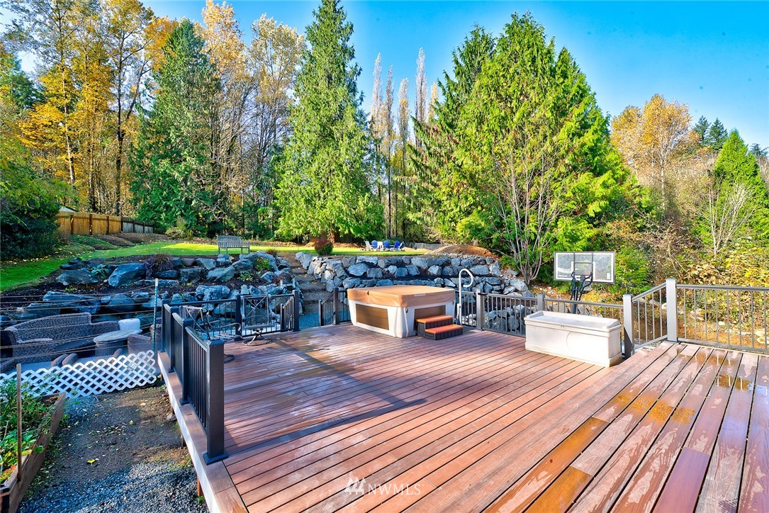 13621 196th Avenue Southeast Renton, WA 98059 - Photo 31 of 31 a view of a patio with dining table and chairs with wooden floor and fence