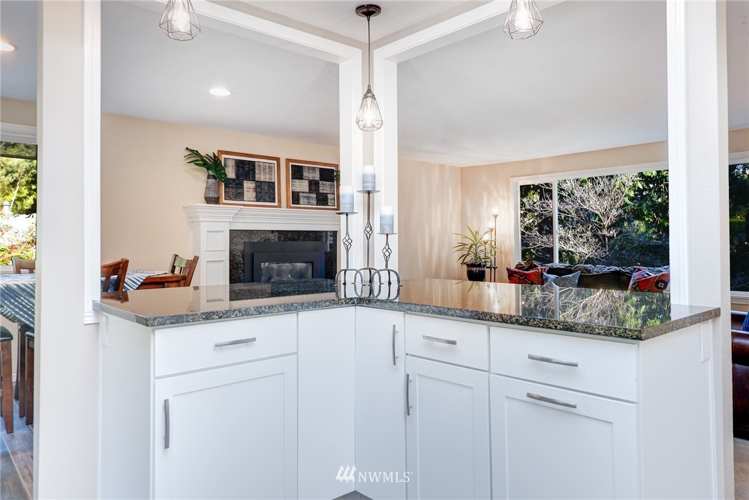 13621 196th Avenue Southeast Renton, WA 98059 - Photo 10 of 31 a kitchen with granite countertop a sink and cabinets with wooden floor