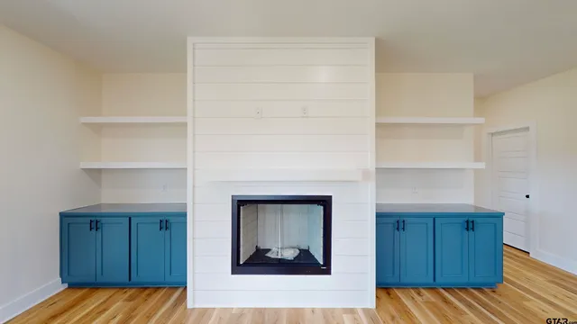 a bedroom with a bed and cabinets