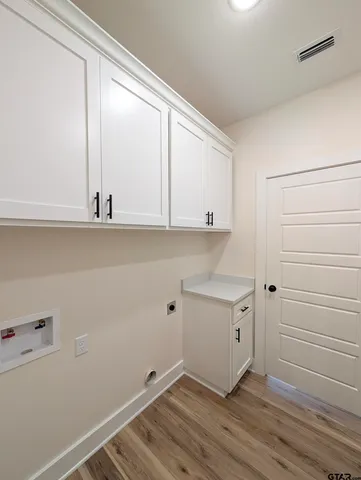 a view of cabinets with wooden floor