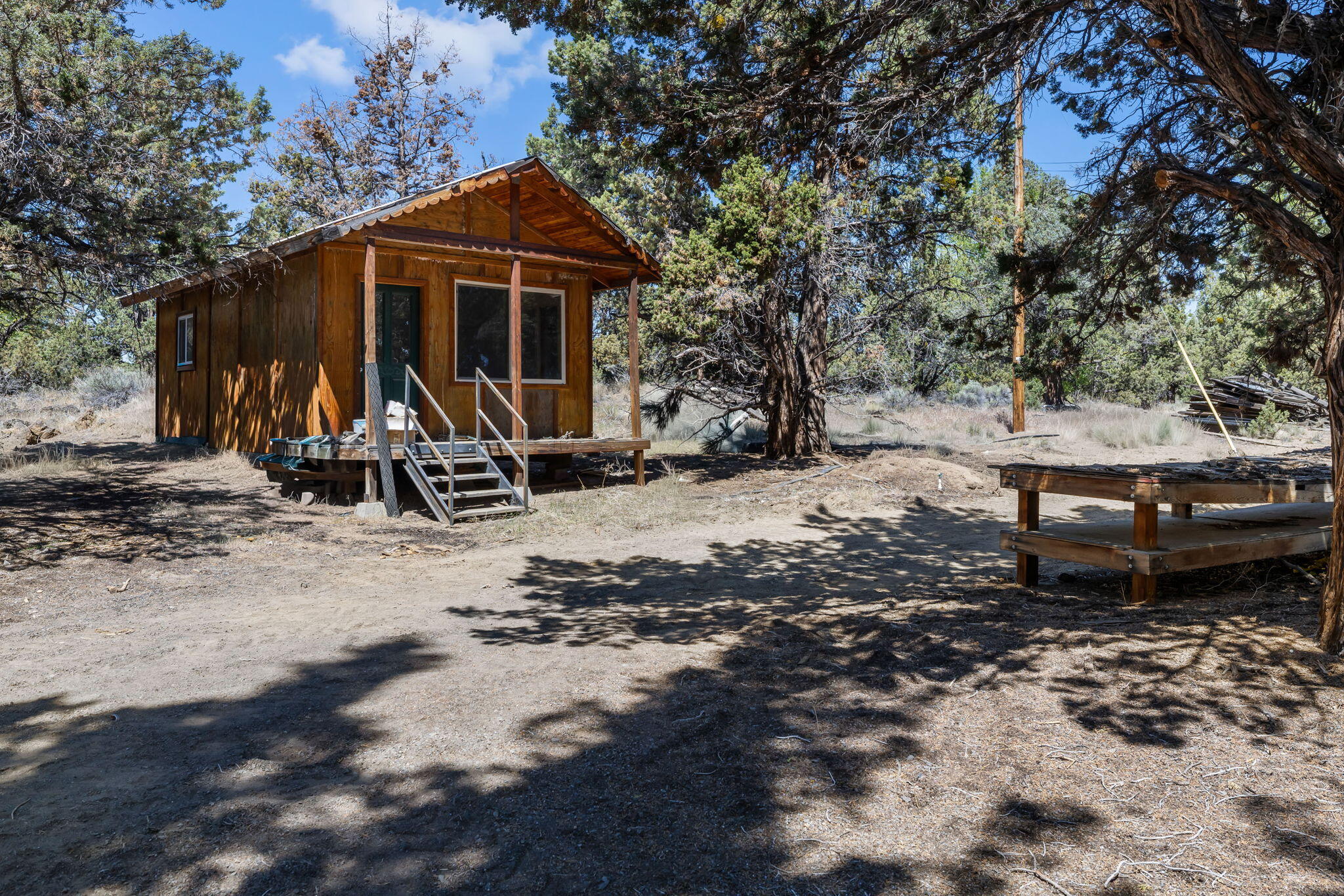 63639 Gentry Loop Bend, OR 97701 - Photo 39 of 40 a view of a backyard with a table and chairs under a large tree