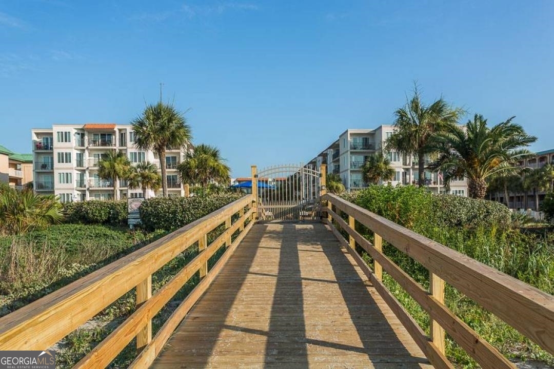 1440 Ocean Boulevard, Unit 119 St. Simons, GA 31522 - Photo 12 of 15 a view of balcony with wooden floor and fence