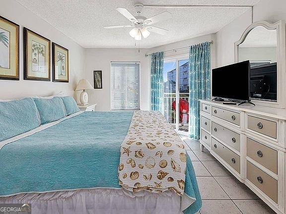 1440 Ocean Boulevard, Unit 119 St. Simons, GA 31522 - Photo 5 of 15 a bedroom with a bed and a flat screen tv