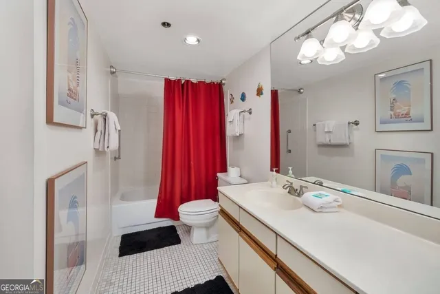 a bathroom with a sink a toilet and shower curtain