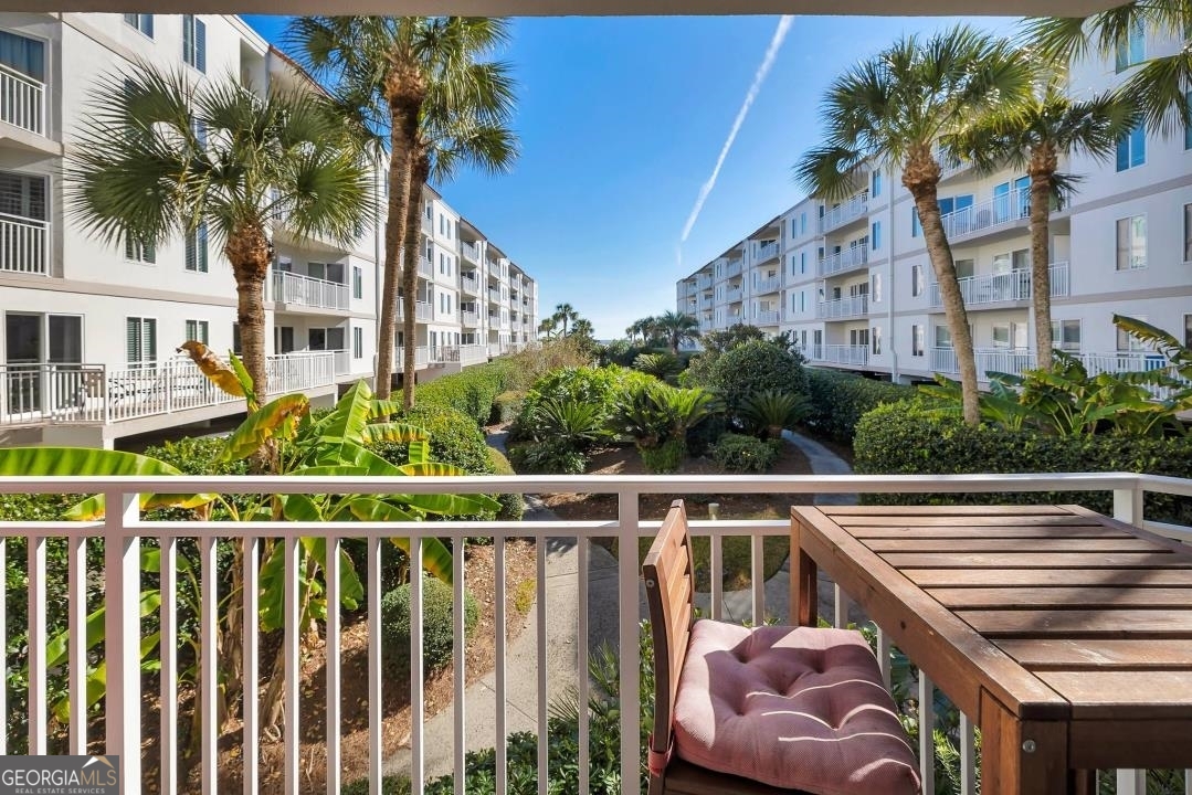 1440 Ocean Boulevard, Unit 119 St. Simons, GA 31522 - Photo 9 of 15 a view of a balcony with two chairs and a table