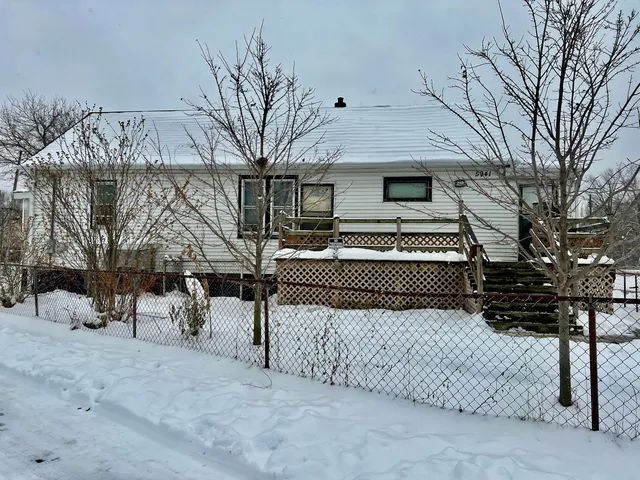 a view of a house with a snow in a yard