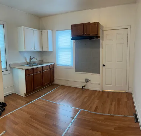 a room view with wooden floor and cabinets