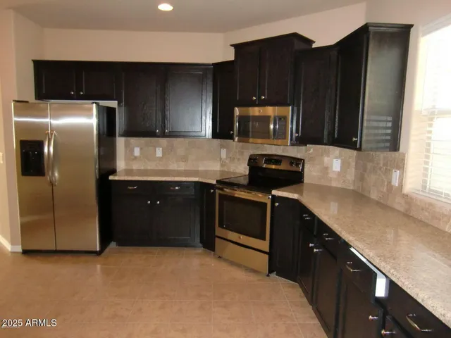 a kitchen with a sink stove and refrigerator