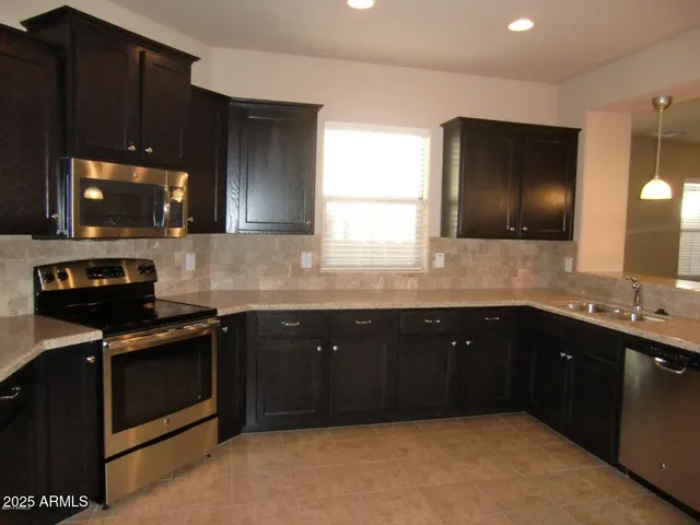 a kitchen with a sink a stove and microwave