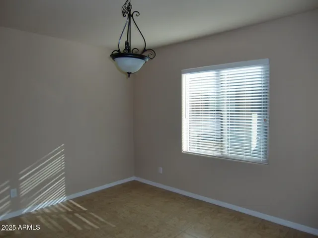 a view of a room with a window and a ceiling fan
