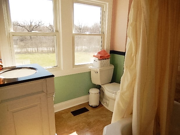 11215 79th Street Burr Ridge, IL 60527 - Photo 17 of 25 a bathroom with a toilet and a sink