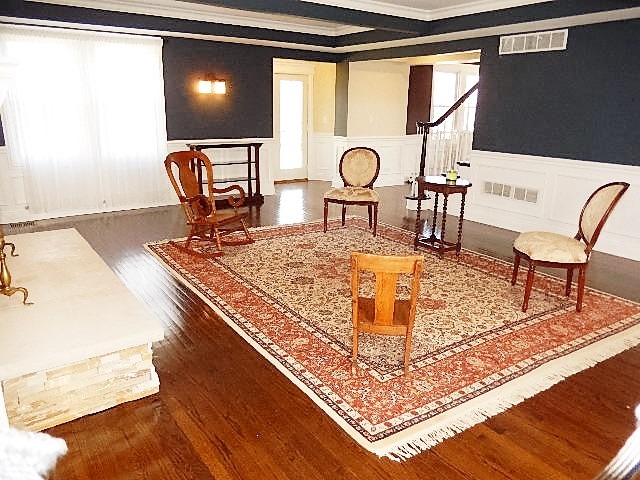 11215 79th Street Burr Ridge, IL 60527 - Photo 4 of 25 a living room with table or chairs and a dining table with wooden floor