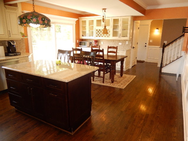 11215 79th Street Burr Ridge, IL 60527 - Photo 7 of 25 a room with wooden floors table and chairs