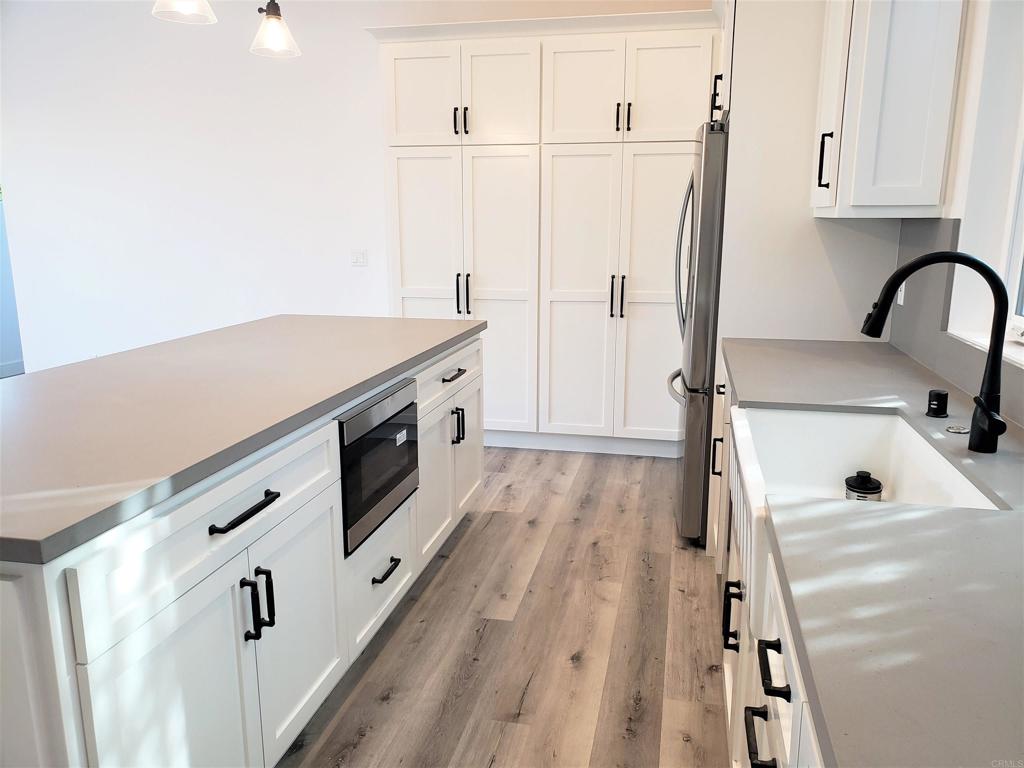 804-814 Clark Avenue Encinitas, CA 92024 - Photo 4 of 18 a kitchen with a sink a refrigerator and cabinets