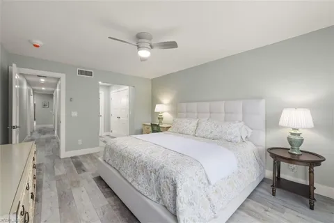 a bedroom with a bed and a lamp