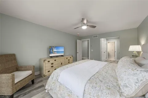 a spacious bedroom with a bed and a couch