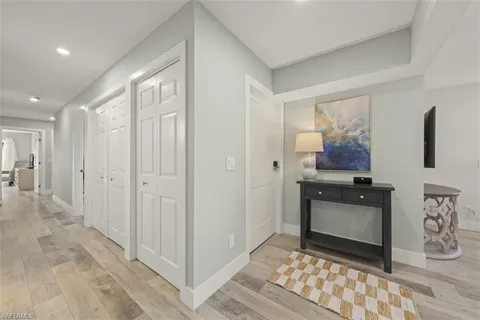 a view of a hallway to rooms and stairs